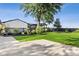 Beautifully landscaped backyard with a spacious lawn, deck, mature trees, and black fence at 3777 W State Road 234, McCordsville, IN 46055