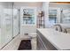 Bright bathroom featuring a tub shower, a large window, and a vanity at 3777 W State Road 234, McCordsville, IN 46055