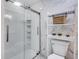 Bathroom featuring a glass shower, toilet, and white marble walls and floor at 3777 W State Road 234, McCordsville, IN 46055