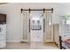 Bathroom featuring a double sink, decorative mirrors, and barn doors at 3777 W State Road 234, McCordsville, IN 46055