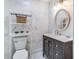 Bathroom featuring a toilet, white marble walls and floor, vanity and shelves at 3777 W State Road 234, McCordsville, IN 46055