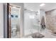 Elegant bathroom showcasing a glass shower, marble walls, and a white toilet at 3777 W State Road 234, McCordsville, IN 46055