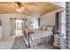 Bedroom featuring a wooden ceiling, a bed with decorative pillows, and a view to the bathroom at 3777 W State Road 234, McCordsville, IN 46055