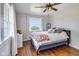 Cozy bedroom with hardwood floors, large windows and a plush-looking bed and furnishings at 3777 W State Road 234, McCordsville, IN 46055