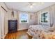 Cozy bedroom with hardwood floors, bright windows, and cottage-style decor at 3777 W State Road 234, McCordsville, IN 46055