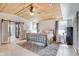 Bedroom featuring a wooden ceiling, a bed with decorative pillows, and a view to the bathroom at 3777 W State Road 234, McCordsville, IN 46055