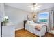 Cozy bedroom features a plush bed, wood floors, and bright natural light at 3777 W State Road 234, McCordsville, IN 46055