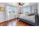 Comfortable bedroom with three bright windows and a ceiling fan at 3777 W State Road 234, McCordsville, IN 46055