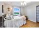 Bright bedroom with hardwood floors, large window, stylish curtains, and ceiling fan at 3777 W State Road 234, McCordsville, IN 46055