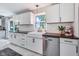 Well-lit kitchen with white cabinets, stainless steel appliances, wood countertops, and a farmhouse sink at 3777 W State Road 234, McCordsville, IN 46055