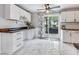 Bright kitchen area with modern cabinets, stone countertops, and a sliding glass door to the backyard at 3777 W State Road 234, McCordsville, IN 46055