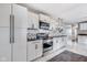 Modern kitchen featuring white cabinets, stainless steel appliances, and marble floors for a clean, contemporary look at 3777 W State Road 234, McCordsville, IN 46055