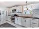 Bright kitchen featuring white cabinets, stainless steel appliances, wood countertops, and marble floors at 3777 W State Road 234, McCordsville, IN 46055