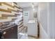 Functional laundry room features modern washer/dryer, stylish wood accent wall and vinyl floors at 3777 W State Road 234, McCordsville, IN 46055
