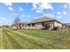 Expansive backyard with lush green grass, mature landscaping, and brick house exterior at 3784 Mansfield Dr, Brownsburg, IN 46112