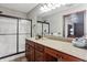 Modern bathroom with a long vanity, framed mirror, walk-in shower, and ample counter space at 3784 Mansfield Dr, Brownsburg, IN 46112