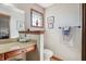 Bathroom featuring a vanity with granite countertops, framed mirror, and toilet at 3784 Mansfield Dr, Brownsburg, IN 46112