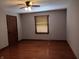 Bedroom featuring warm hardwood floors, a ceiling fan, and a window with wood blinds at 3784 Mansfield Dr, Brownsburg, IN 46112