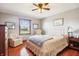 Serene bedroom featuring hardwood floors, a ceiling fan, natural light, and neutral tones, providing a calming space at 3784 Mansfield Dr, Brownsburg, IN 46112