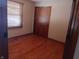 Cozy bedroom features wooden floors, a window with blinds, and a closet at 3784 Mansfield Dr, Brownsburg, IN 46112