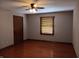 Bedroom featuring warm hardwood floors, a ceiling fan, and a window with wood blinds at 3784 Mansfield Dr, Brownsburg, IN 46112