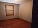 This bedroom features hardwood floors and a window with blinds to let in natural light at 3784 Mansfield Dr, Brownsburg, IN 46112