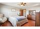 Comfortable bedroom with hardwood floors, a cushioned headboard, sitting chair, and dresser at 3784 Mansfield Dr, Brownsburg, IN 46112