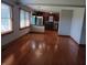 Open dining room featuring hardwood floors, natural light, and view to kitchen at 3784 Mansfield Dr, Brownsburg, IN 46112