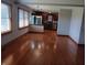 Open dining room featuring hardwood floors, natural light, and view to kitchen at 3784 Mansfield Dr, Brownsburg, IN 46112