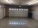 Interior view of garage with white door and epoxy floor at 3784 Mansfield Dr, Brownsburg, IN 46112