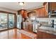 Modern kitchen featuring stainless steel appliances, wood cabinets, and access to a screened porch at 3784 Mansfield Dr, Brownsburg, IN 46112