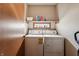 Bright laundry room features a washer, dryer, and shelf with supplies at 3784 Mansfield Dr, Brownsburg, IN 46112