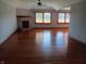 Spacious living room with hardwood floors, fireplace and natural light from two windows at 3784 Mansfield Dr, Brownsburg, IN 46112