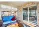 A cozy sunroom with outdoor furniture, brick accent walls, and sliding doors at 3784 Mansfield Dr, Brownsburg, IN 46112