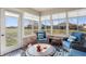 Bright sunroom filled with natural light, brick accent wall, and outdoor views at 3784 Mansfield Dr, Brownsburg, IN 46112