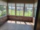 Bright sunroom with large windows offering natural light, brick accents, and stone-like flooring at 3784 Mansfield Dr, Brownsburg, IN 46112