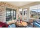 Cozy sunroom with brick accents, large windows, and comfortable seating, creating a relaxing retreat at 3784 Mansfield Dr, Brownsburg, IN 46112