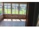 Bright sunroom with large windows offering natural light, brick accents, and stone-like flooring at 3784 Mansfield Dr, Brownsburg, IN 46112