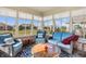 Bright sunroom with lots of windows, comfortable seating, and an inviting atmosphere for relaxation and enjoyment at 3784 Mansfield Dr, Brownsburg, IN 46112