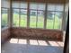 Bright sunroom with large windows offering natural light, brick accents, and stone-like flooring at 3784 Mansfield Dr, Brownsburg, IN 46112