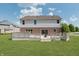 View of the back of the home, with a brick exterior and a large deck and backyard at 4150 Huntsman Dr, Zionsville, IN 46077
