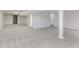 Expansive finished basement featuring neutral carpeting, support columns, and recessed lighting at 4150 Huntsman Dr, Zionsville, IN 46077