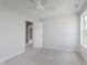 Bright and airy carpeted bedroom with neutral walls, ceiling fan, and window at 4150 Huntsman Dr, Zionsville, IN 46077
