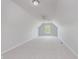 Large bonus room featuring neutral carpeting, a ceiling fan, and a bright window at 4150 Huntsman Dr, Zionsville, IN 46077