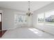 Bright dining room featuring large windows, neutral carpet, and an elegant chandelier at 4150 Huntsman Dr, Zionsville, IN 46077
