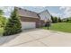 View of the driveway and basketball hoop attached to the side of the house at 4150 Huntsman Dr, Zionsville, IN 46077