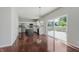 Open floor plan of the kitchen featuring stainless steel appliances, white cabinets, and hardwood flooring at 4150 Huntsman Dr, Zionsville, IN 46077