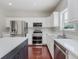 Bright kitchen with stainless steel appliances, white cabinets, quartz countertops, and hardwood flooring at 4150 Huntsman Dr, Zionsville, IN 46077