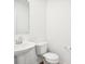 Small bathroom with pedestal sink and white toilet at 430 Louisiana Dr, Pittsboro, IN 46167