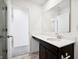 Contemporary bathroom featuring a dark vanity, white counter, and sleek fixtures at 430 Louisiana Dr, Pittsboro, IN 46167